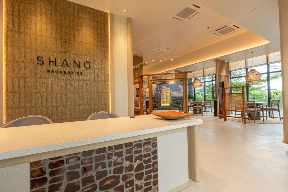 Luxury real estate showroom interior featuring Shang Properties branding, modern design elements, and a premium property consultation space.