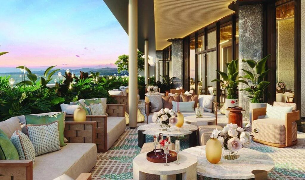 Artist’s rendering of a landscaped outdoor terrace with cushioned seating, round tables, tropical plants, and a panoramic sunset view