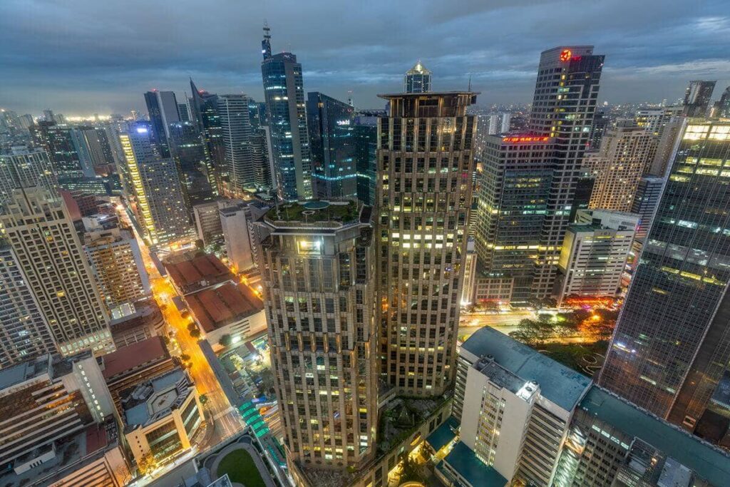 Luxury condominium towers within a dense city skyline at dusk, representing premium urban living and long-term property value