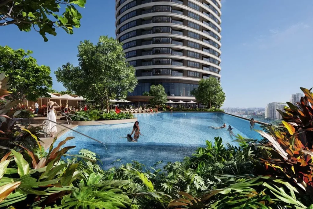 Resort-style condominium swimming pool surrounded by lush landscaping and a high-rise residential tower, reflecting well-maintained luxury amenities