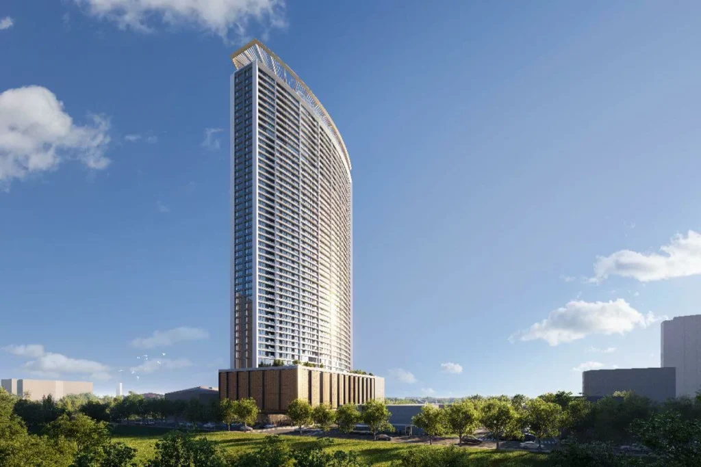 Shang Bauhinia Residences luxury condominium tower rising above landscaped grounds with a sleek modern architectural design.